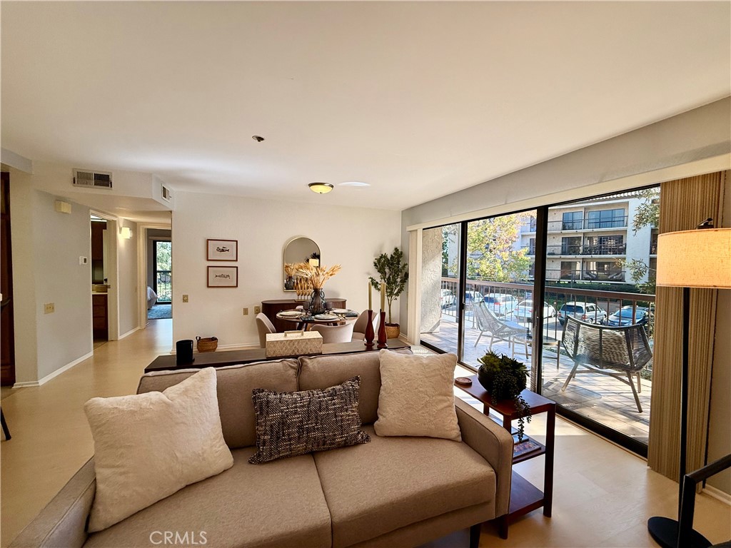 13601 Del Monte Drive, Unit 47A Seal Beach, CA 90740 - Photo 10 of 27 a living room with furniture and a floor to ceiling window