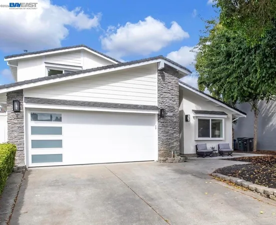 a view of a house with a yard and garage
