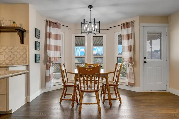 a view of a dining room with furniture window and wooden floor