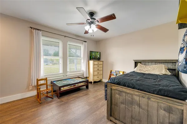 a view of a hallway and a dining room with wooden floor