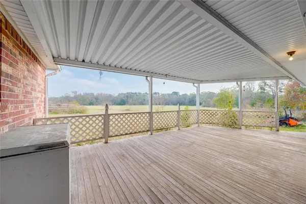 a view of a balcony with wooden floor and outdoor space