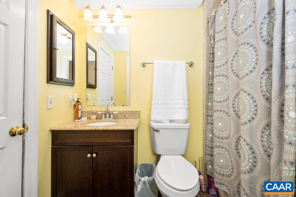2765 Gelletly Road Charlottesville, VA 22902 - Photo 23 of 42 a bathroom with a toilet sink vanity and mirror
