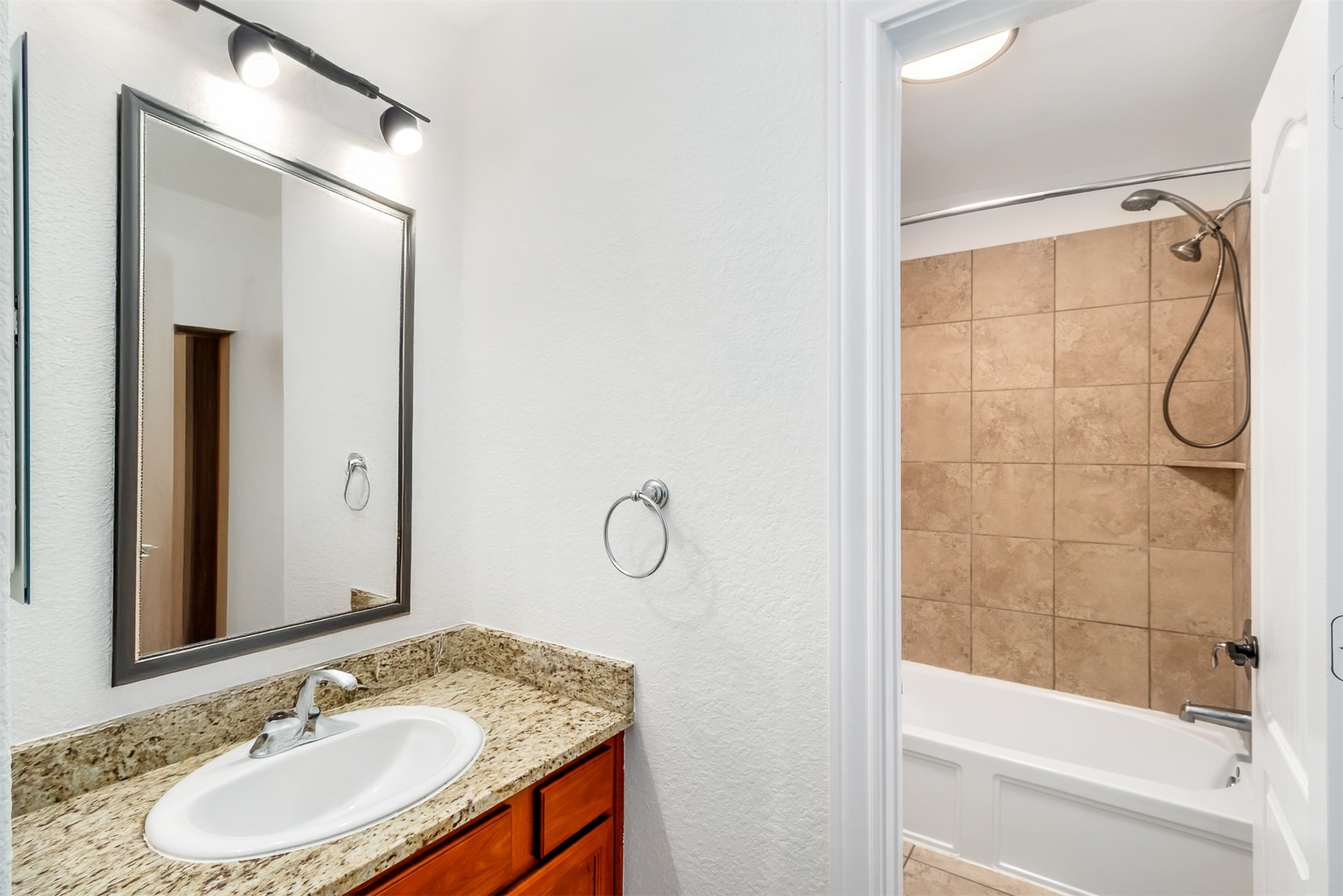 142 Pinto Point Place Spring, TX 77389 - Photo 25 of 36 a bathroom with a granite countertop sink a mirror and a shower