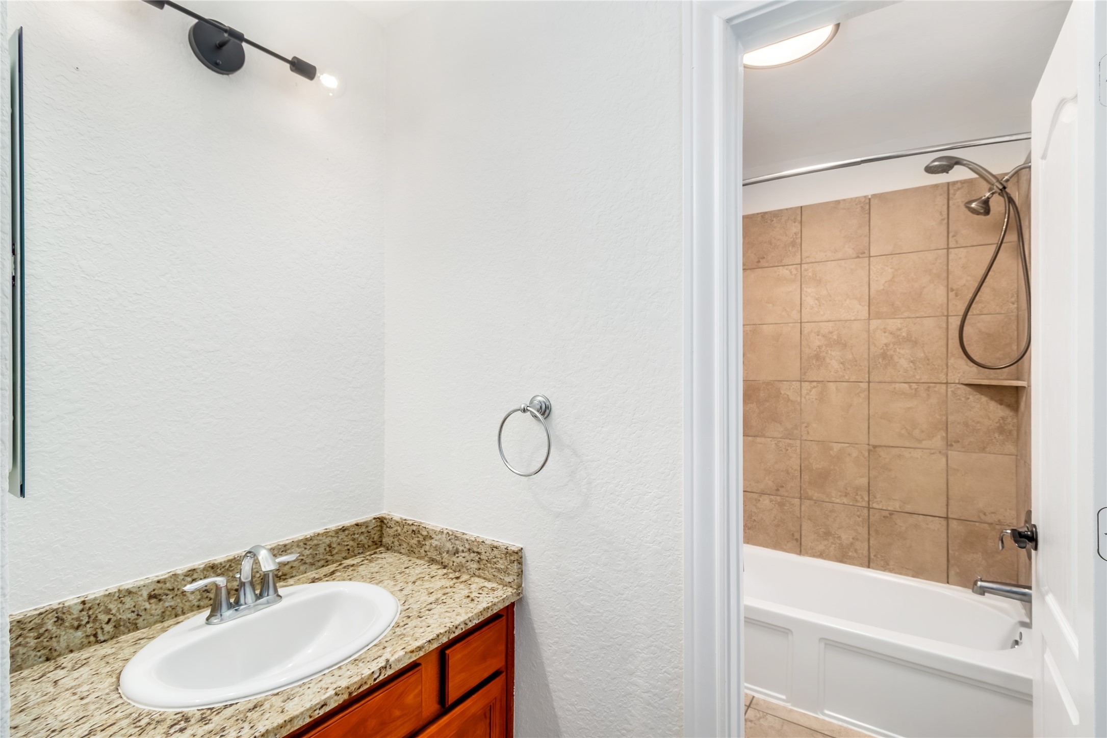 142 Pinto Point Place Spring, TX 77389 - Photo 26 of 36 a bathroom with a granite countertop sink and a mirror