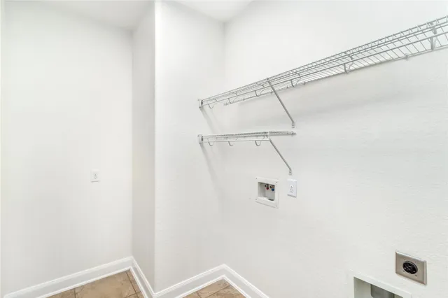 a kitchen with white cabinets and a window