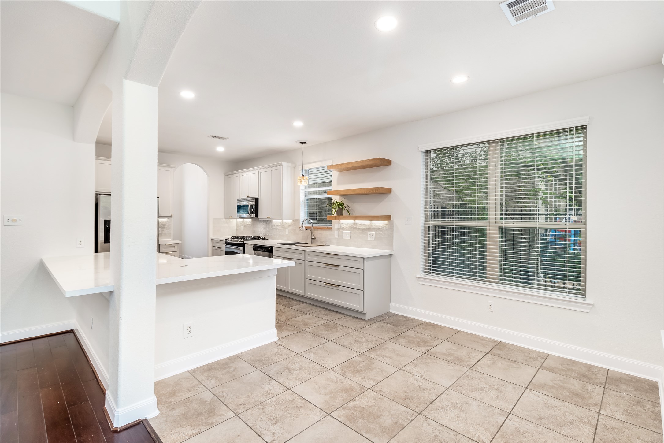 142 Pinto Point Place Spring, TX 77389 - Photo 31 of 36 a kitchen with white cabinets and a window