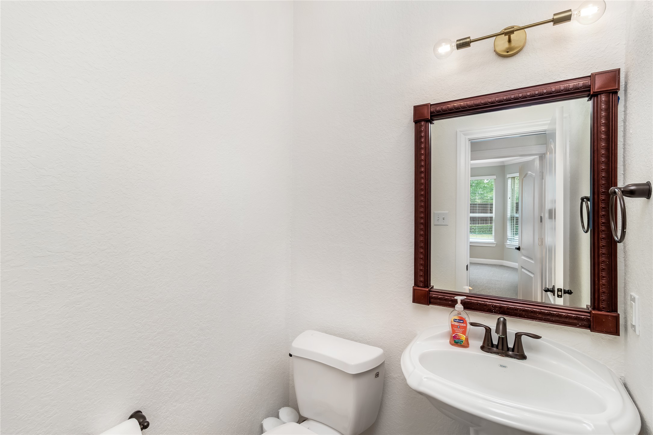 142 Pinto Point Place Spring, TX 77389 - Photo 33 of 36 a bathroom with a toilet a sink and mirror