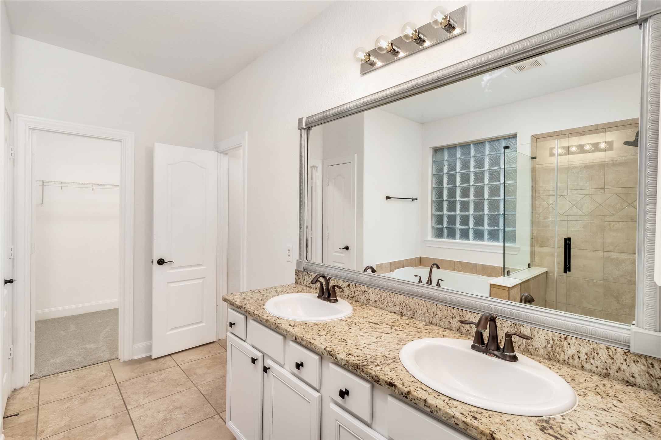 142 Pinto Point Place Spring, TX 77389 - Photo 35 of 36 a bathroom with a granite countertop sink and a mirror