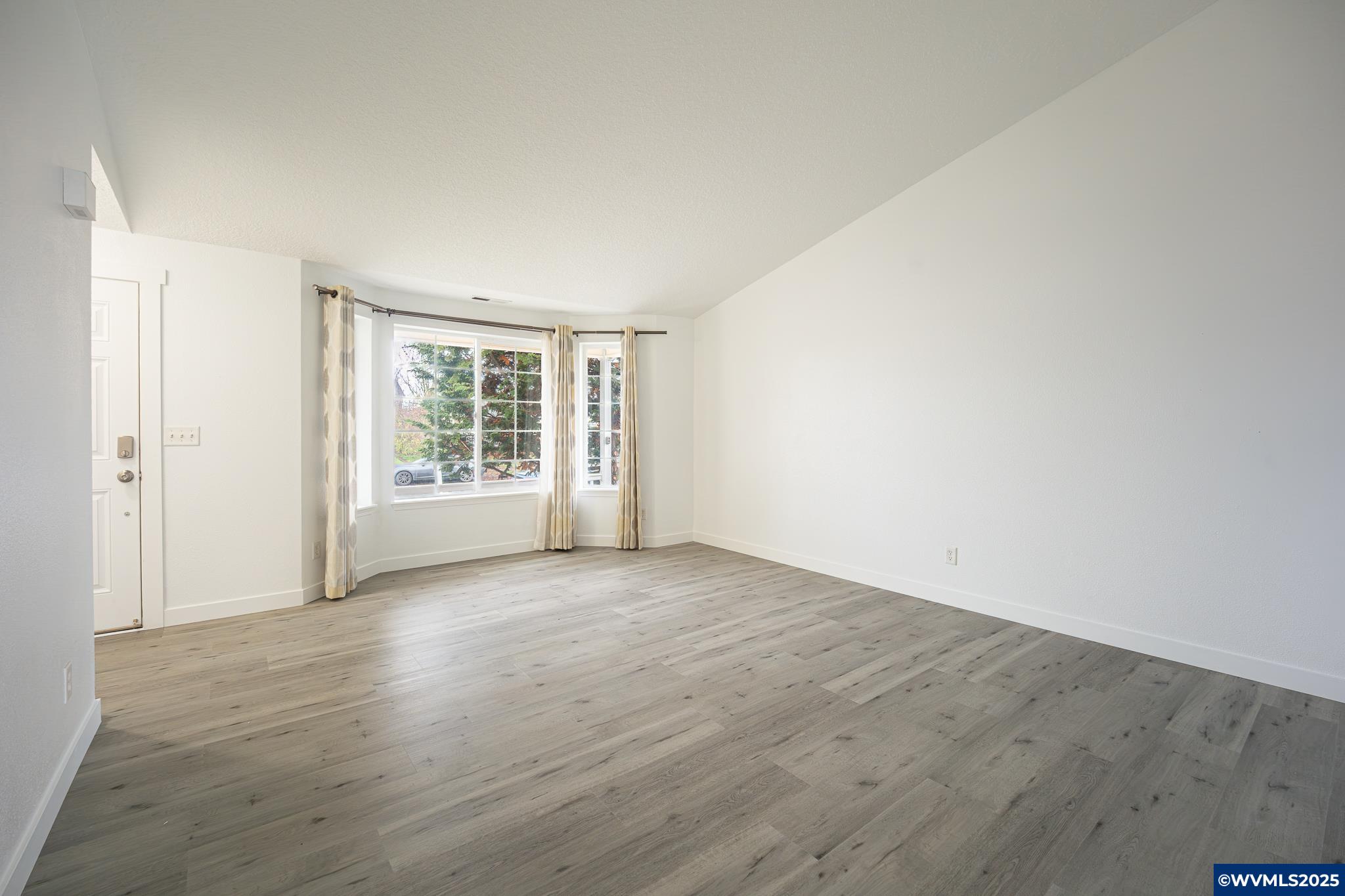 1467 South 7th Street Independence, OR 97351 - Photo 5 of 31 an empty room with wooden floor and windows
