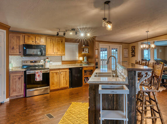 6341 Farm Private Road Levelland, TX 79336 - Photo 11 of 46 a kitchen with kitchen island granite countertop lots of counter top space and stainless steel appliances