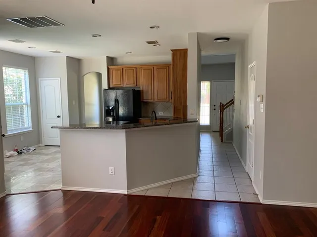 a view of a kitchen cabinets and a wooden floor