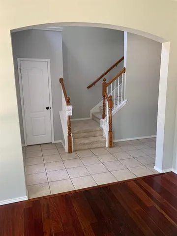a view of entryway and hall with wooden floor