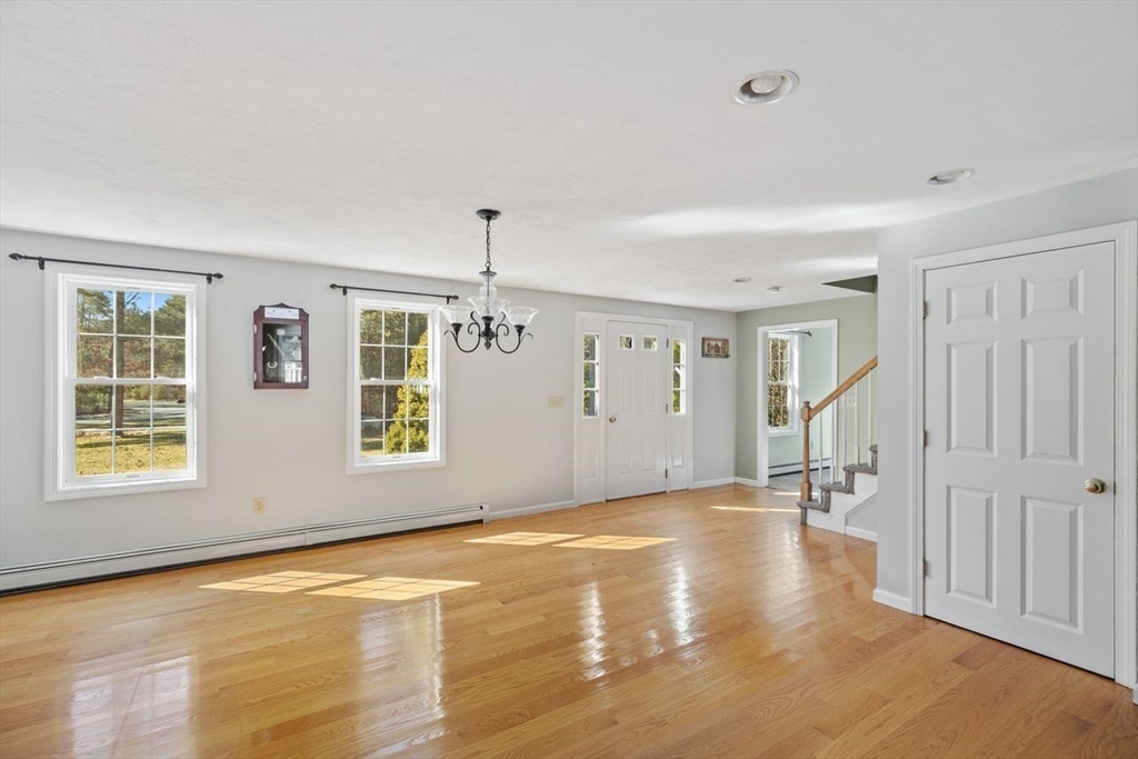 102 Haskell Ridge Road Rochester, MA 02770 - Photo 13 of 36 a view of an empty room with wooden floor and a window