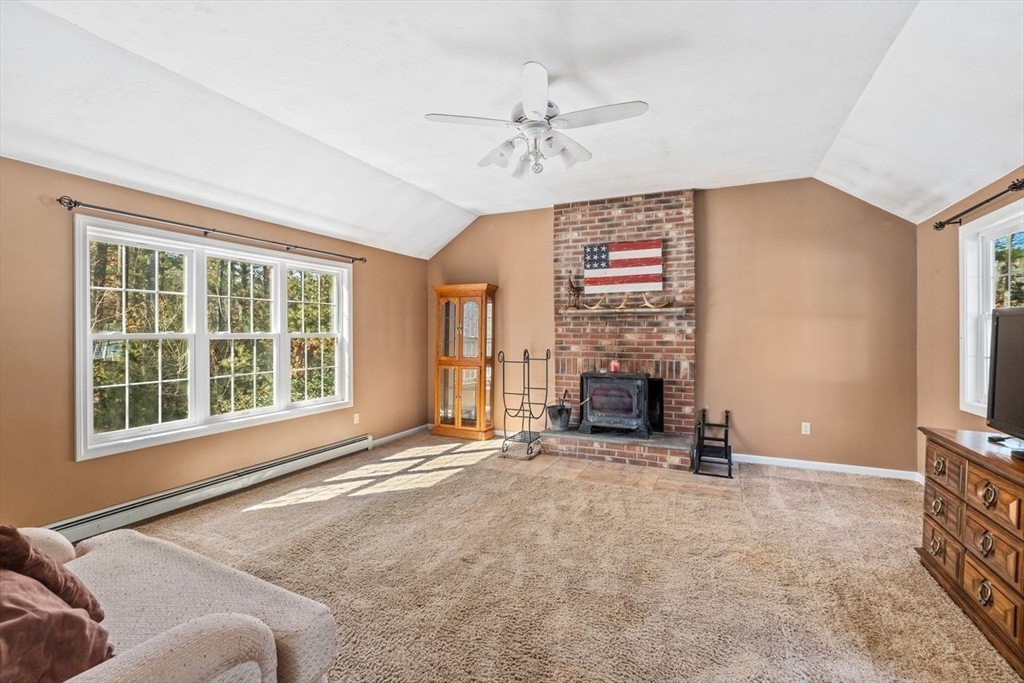102 Haskell Ridge Road Rochester, MA 02770 - Photo 15 of 36 a view of an empty room with a fireplace and a window