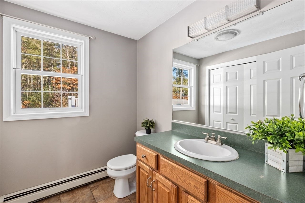 102 Haskell Ridge Road Rochester, MA 02770 - Photo 25 of 36 a bathroom with a granite countertop sink and a mirror with toilet