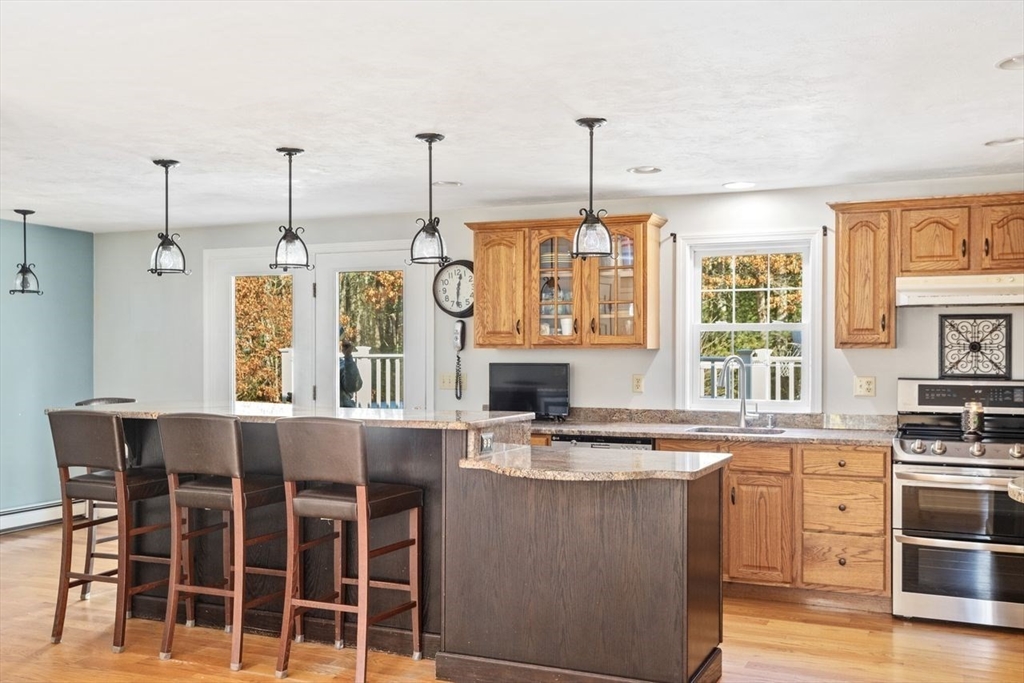 102 Haskell Ridge Road Rochester, MA 02770 - Photo 4 of 36 a view of a kitchen with stainless steel appliances granite countertop a stove and a wooden floors