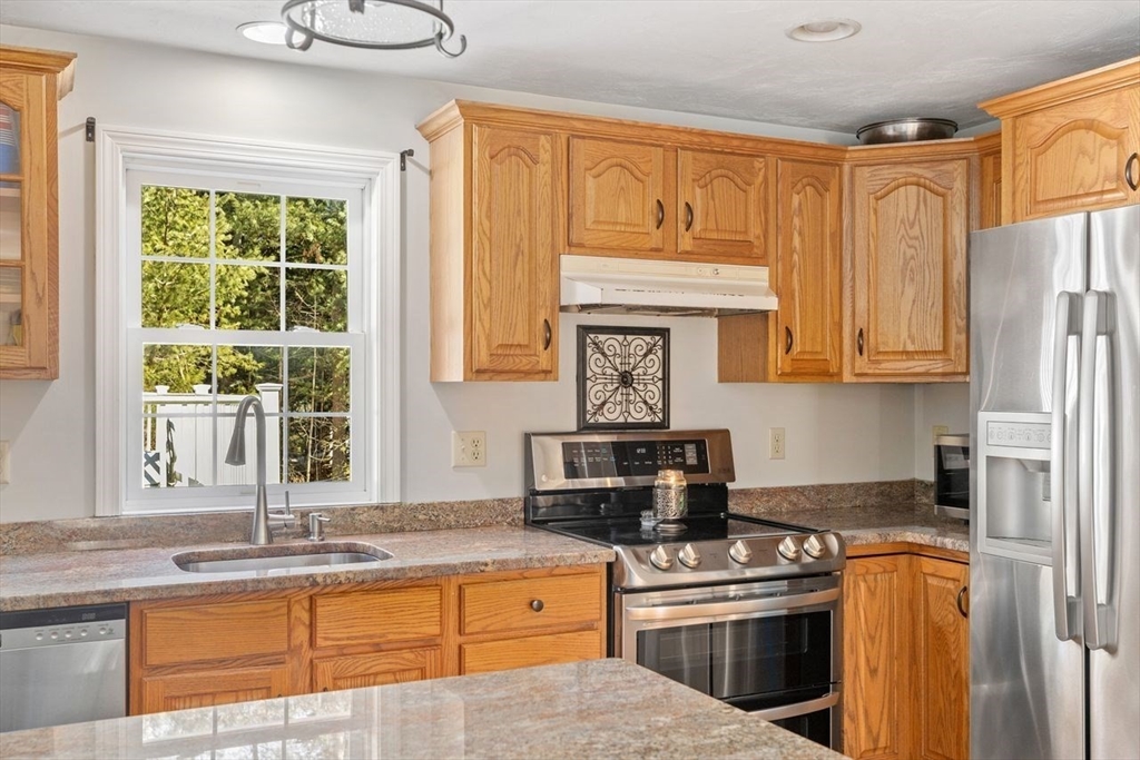 102 Haskell Ridge Road Rochester, MA 02770 - Photo 9 of 36 a kitchen with stainless steel appliances granite countertop a stove a sink and a microwave