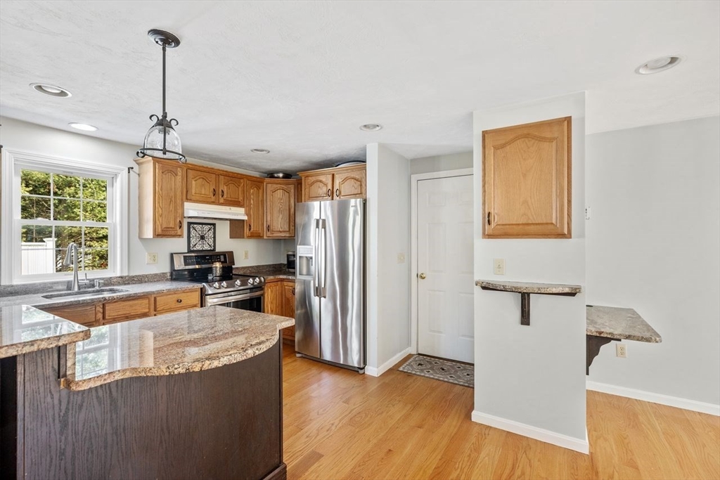 102 Haskell Ridge Road Rochester, MA 02770 - Photo 10 of 36 a kitchen with granite countertop a sink a counter space appliances and cabinets
