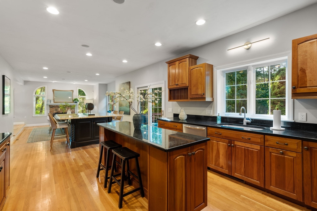 15 Broad Acres Farm Road Medway, MA 02053 - Photo 12 of 42 a kitchen with stainless steel appliances granite countertop sink stove and wooden cabinets