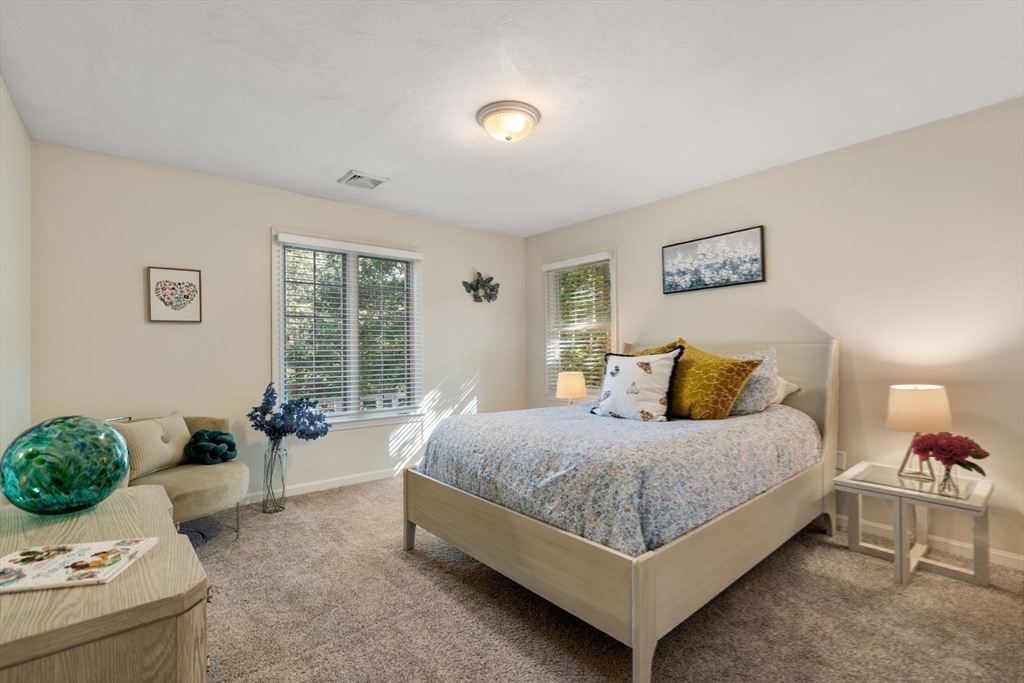 15 Broad Acres Farm Road Medway, MA 02053 - Photo 25 of 42 a spacious bedroom with a bed and a couch