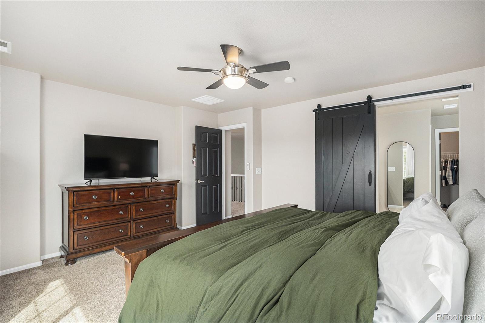 2470 Robindale Way Castle Rock, CO 80109 - Photo 22 of 42 a bedroom with a bed and a flat screen tv