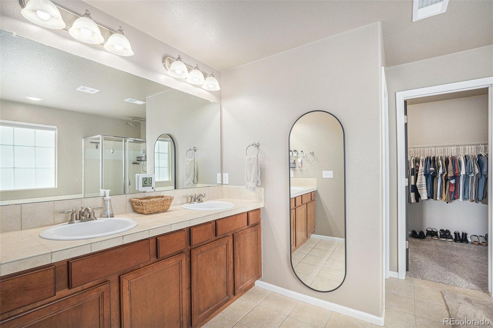 2470 Robindale Way Castle Rock, CO 80109 - Photo 23 of 42 a en suite bathroom with a granite countertop sink and a mirror