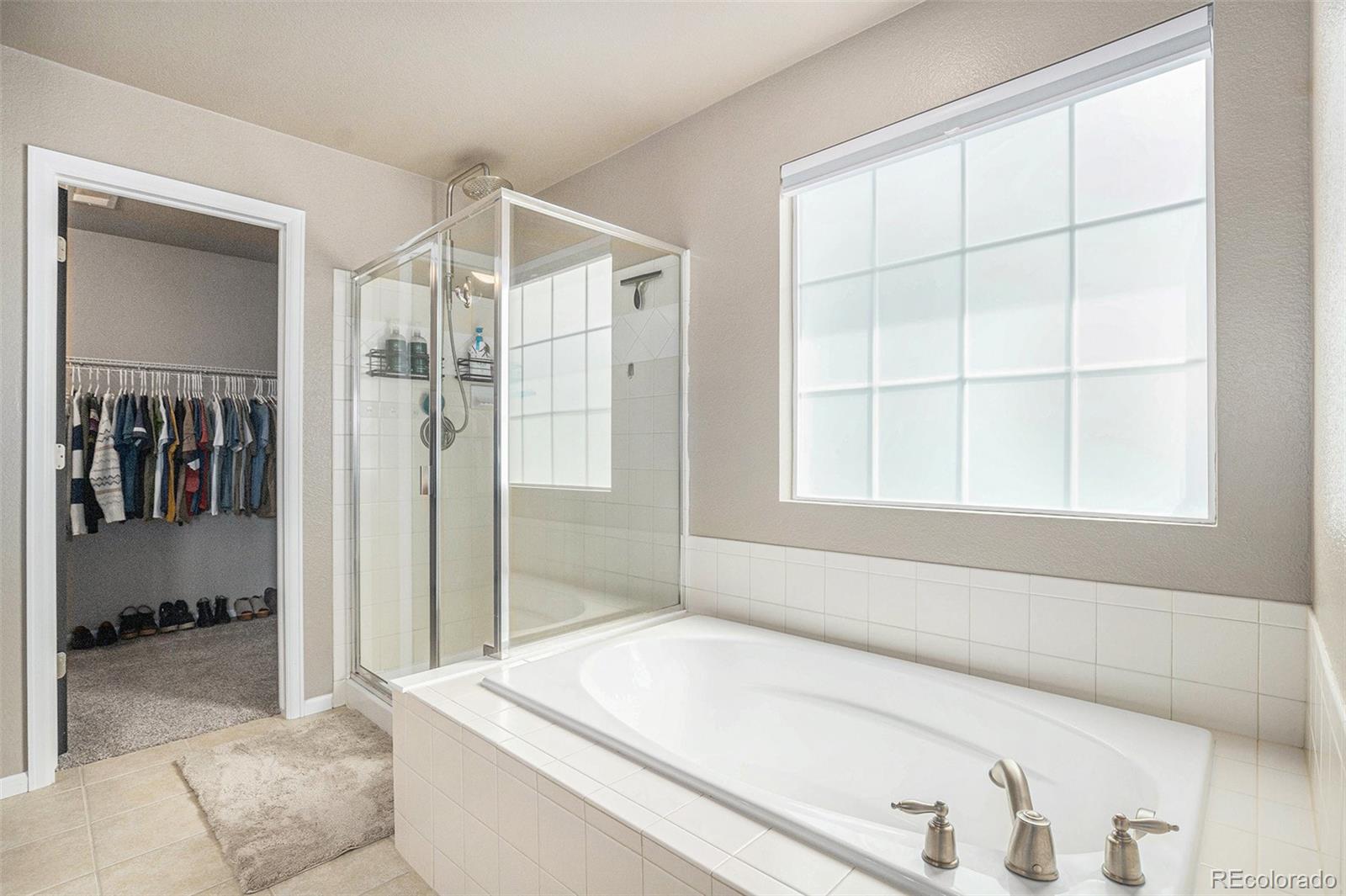 2470 Robindale Way Castle Rock, CO 80109 - Photo 24 of 42 a bathroom with a tub and a shower