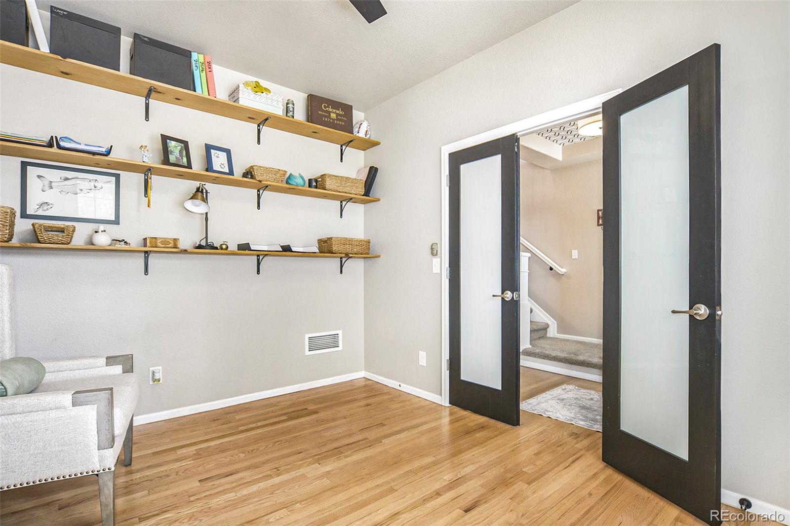 2470 Robindale Way Castle Rock, CO 80109 - Photo 5 of 42 a view of a room with rack and wooden floor