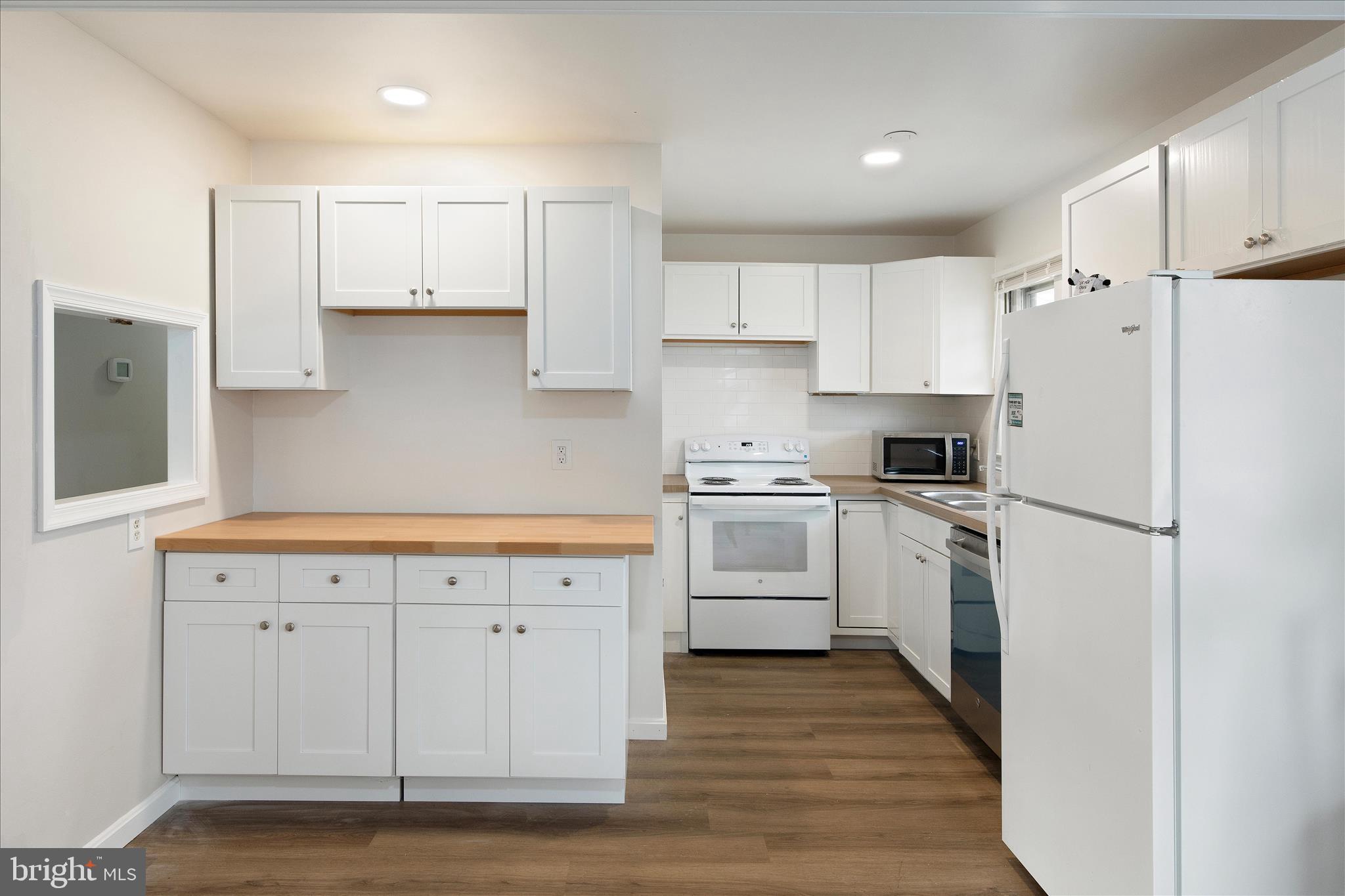 802 Lucky Road Severn, MD 21144 - Photo 13 of 32 a kitchen with white cabinets and white appliances