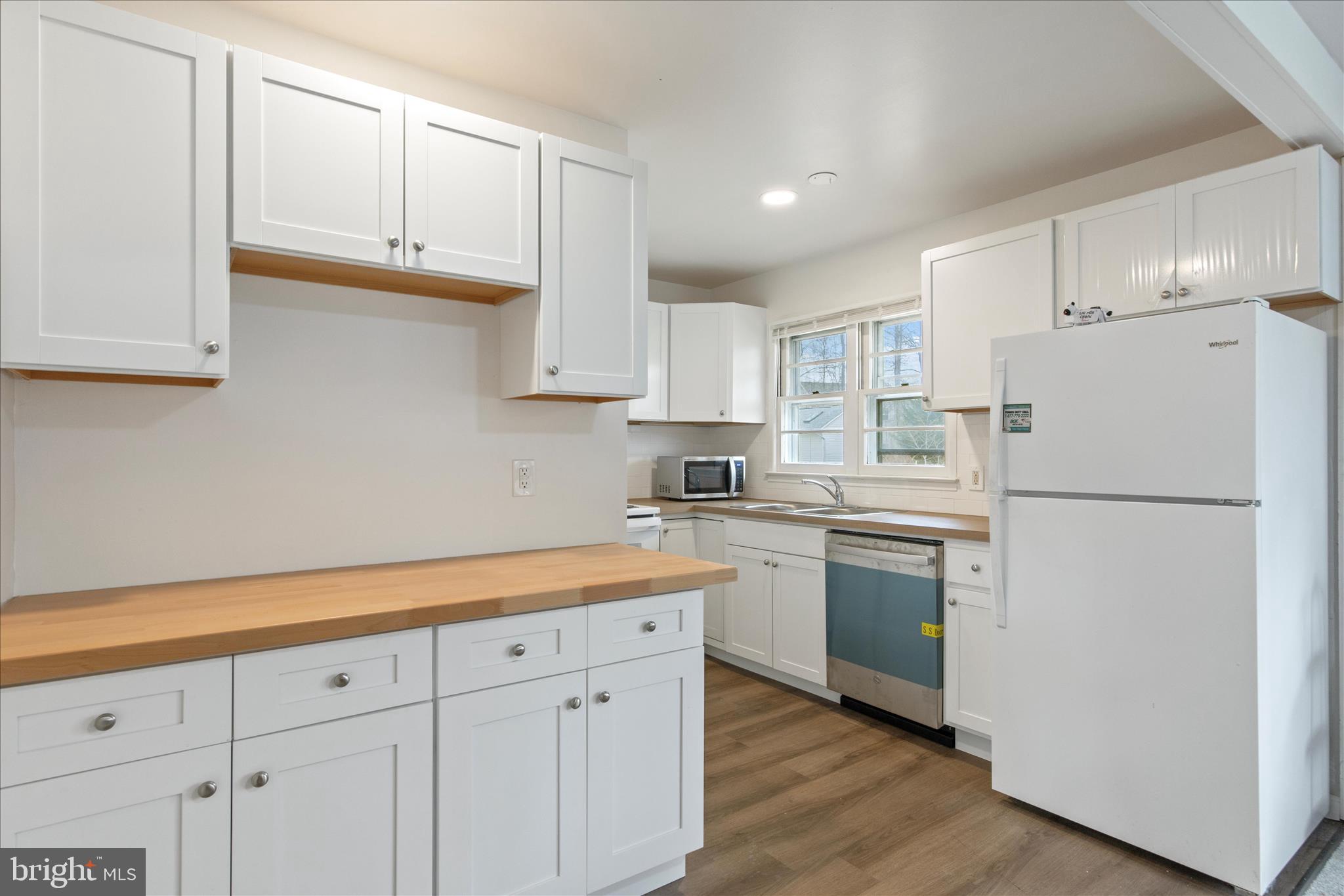 802 Lucky Road Severn, MD 21144 - Photo 14 of 32 a kitchen with cabinets appliances a sink and a counter space