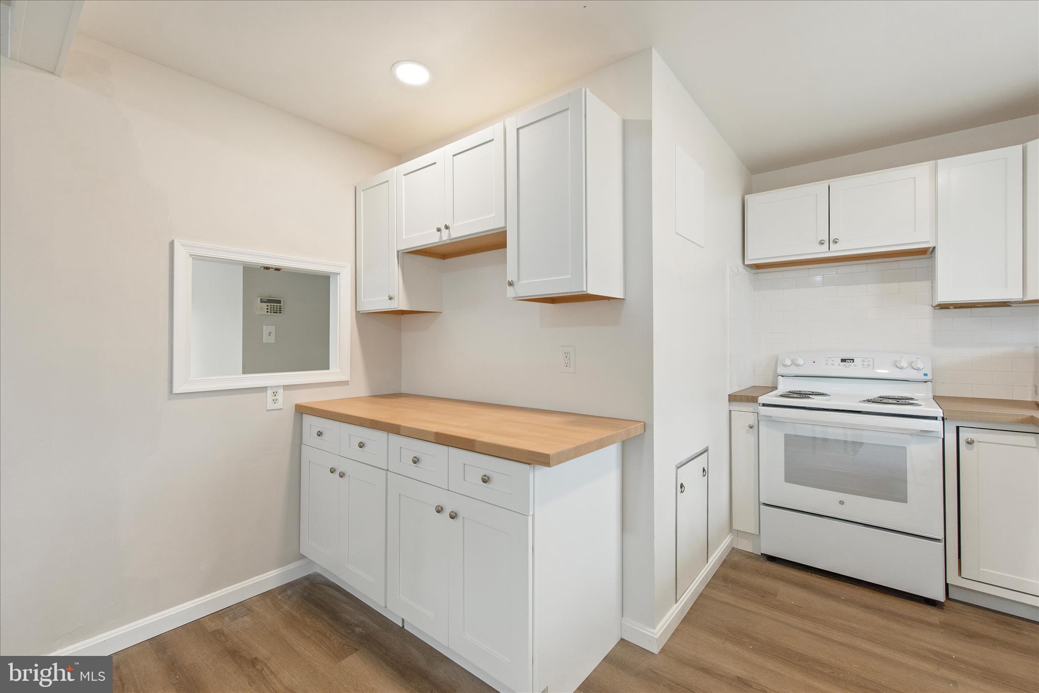 802 Lucky Road Severn, MD 21144 - Photo 15 of 32 a kitchen with white cabinets and white appliances