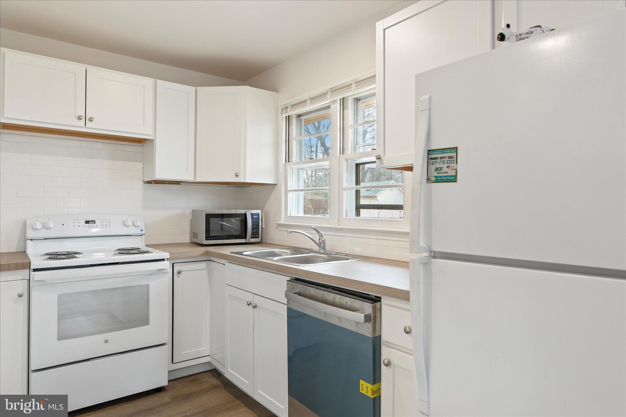 802 Lucky Road Severn, MD 21144 - Photo 16 of 32 a kitchen with cabinets stainless steel appliances and a sink