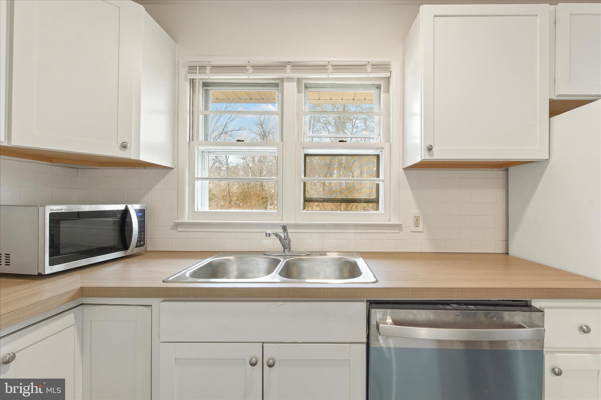 802 Lucky Road Severn, MD 21144 - Photo 17 of 32 a kitchen with stainless steel appliances granite countertop a sink and a microwave