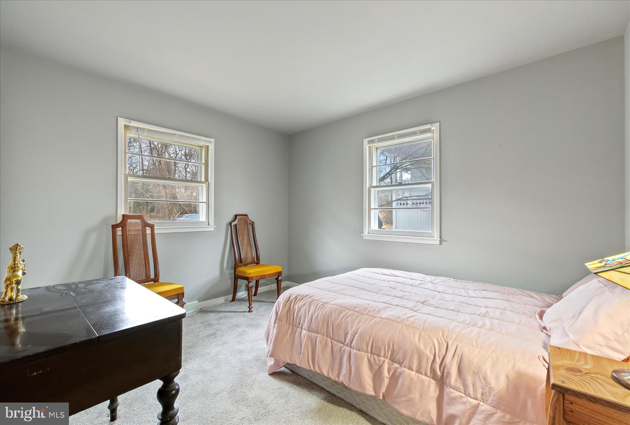 802 Lucky Road Severn, MD 21144 - Photo 18 of 32 a bedroom with a bed a table and a window