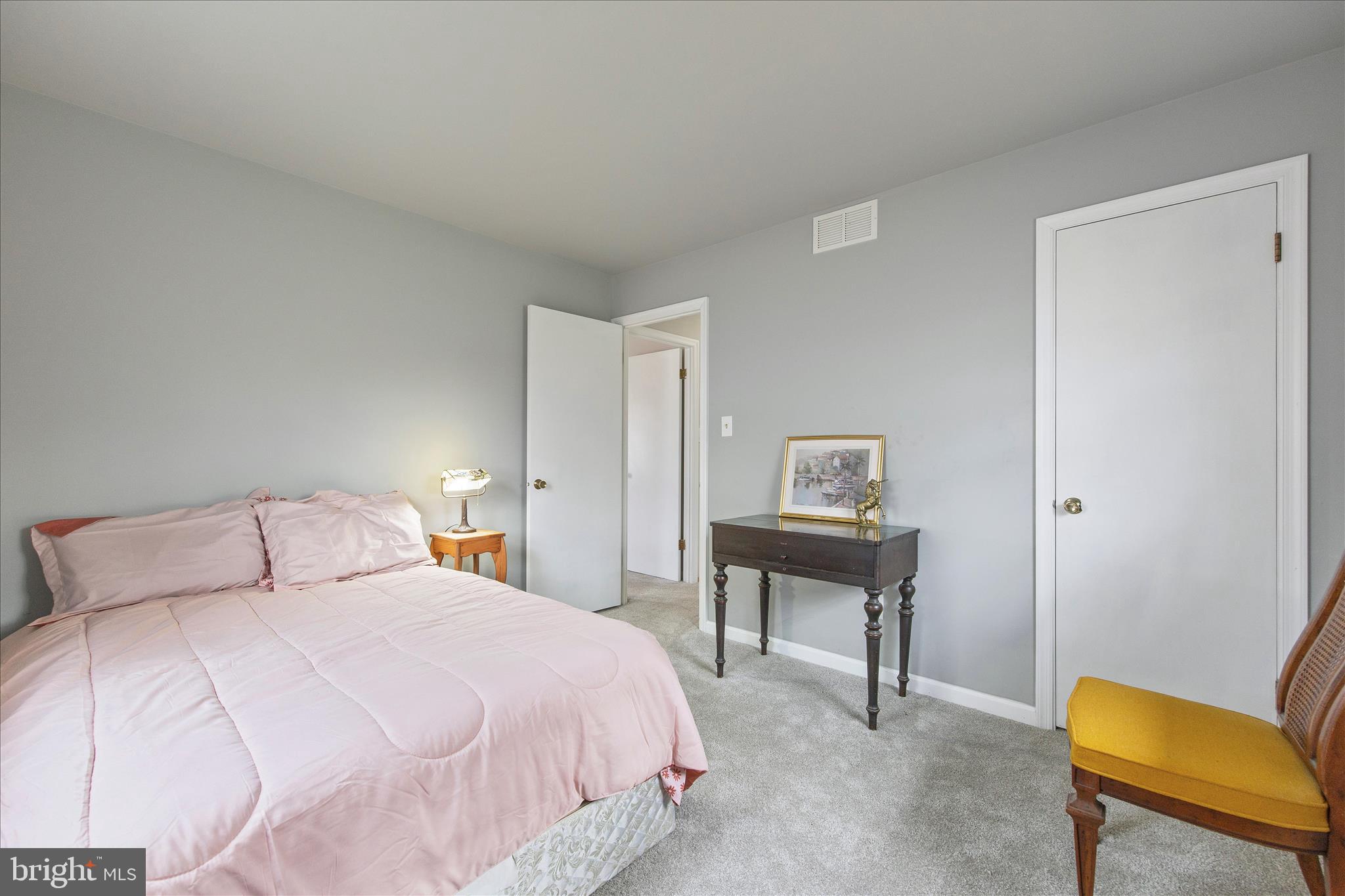 802 Lucky Road Severn, MD 21144 - Photo 19 of 32 a bedroom with a bed and chair