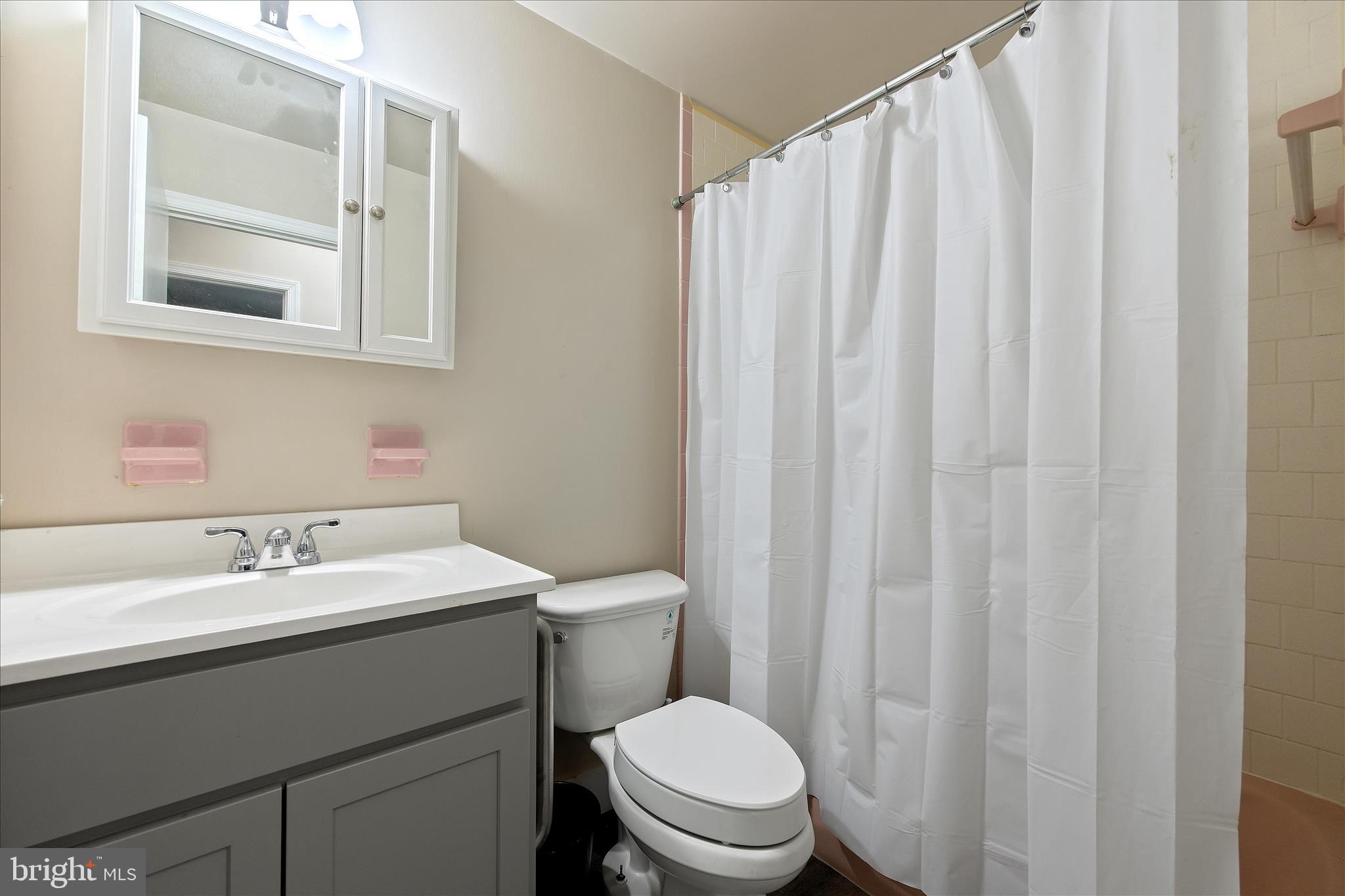 802 Lucky Road Severn, MD 21144 - Photo 24 of 32 a bathroom with a toilet a sink and a mirror