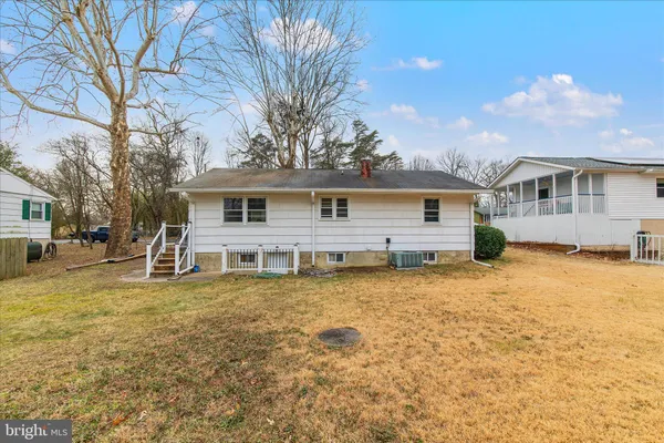a view of a house with a yard and sitting area