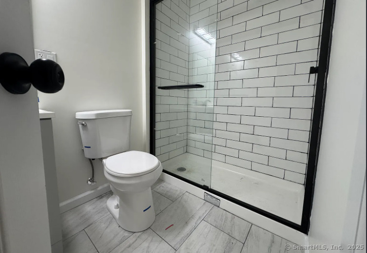 61 Field Street, Unit 211 Waterbury, CT 06702 - Photo 4 of 11 a bathroom with a toilet and a shower