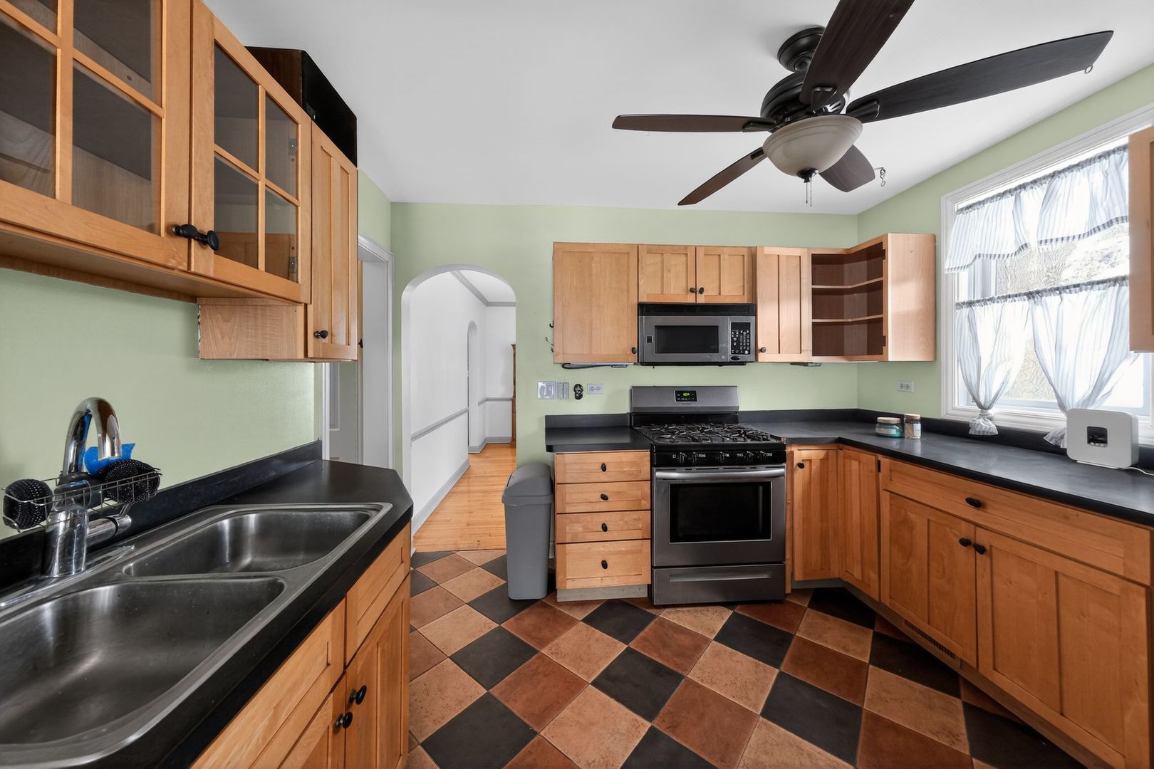 521 Deerfield Road Deerfield, IL 60015 - Photo 11 of 30 a kitchen with stainless steel appliances granite countertop a sink a stove top oven a granite counter space and a window