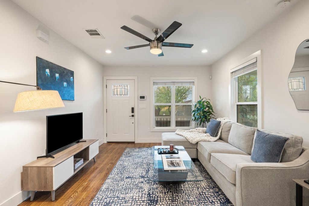 2702 Crest Avenue, Unit 1 Austin, TX 78702 - Photo 6 of 29 The light-filled living room showcases beautiful hardwood flooring and recessed lighting throughout.