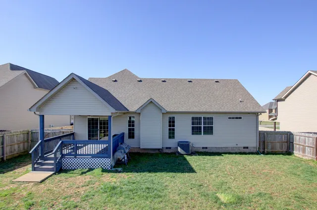 a view of a house with a big yard and potted plants