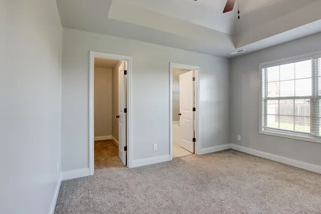 an empty room with windows and closet