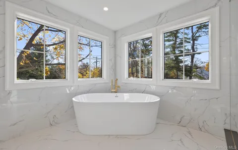 a white bath tub sitting next to a window