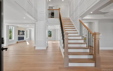 a view of entryway and hall with wooden floor