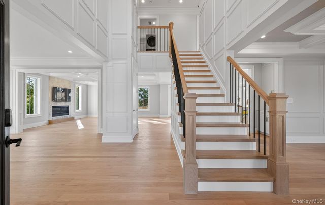 a view of entryway and hall with wooden floor