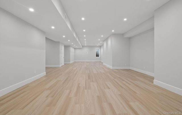 a view of a big room with wooden floor and natural light