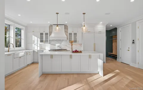 a view of kitchen with stainless steel appliances granite countertop cabinets and wooden floor