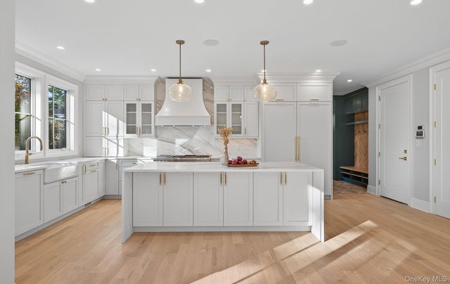 a view of kitchen with stainless steel appliances granite countertop cabinets and wooden floor