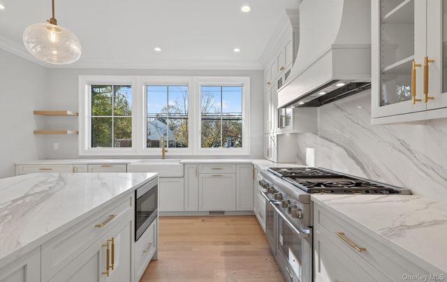 a kitchen with a sink stove and window