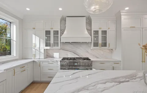 a kitchen with stainless steel appliances granite countertop a stove and a sink